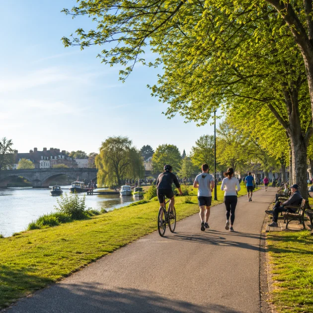 People walking, running and cycling through Richmond Park near East Sheen on a sunny day