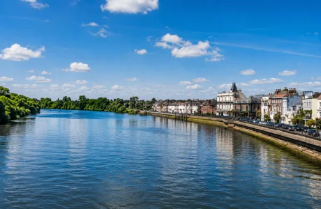 View of the River Thames and Mortlake riverside in Mortlake, London, with historic buildings and the waterfront promenade.