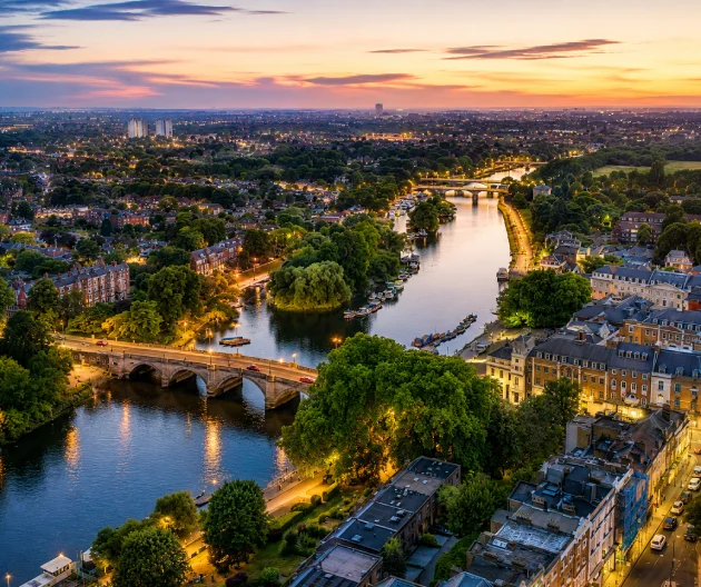 Aerial view of Richmond, London, showing the River Thames, Richmond Bridge and surrounding green spaces.